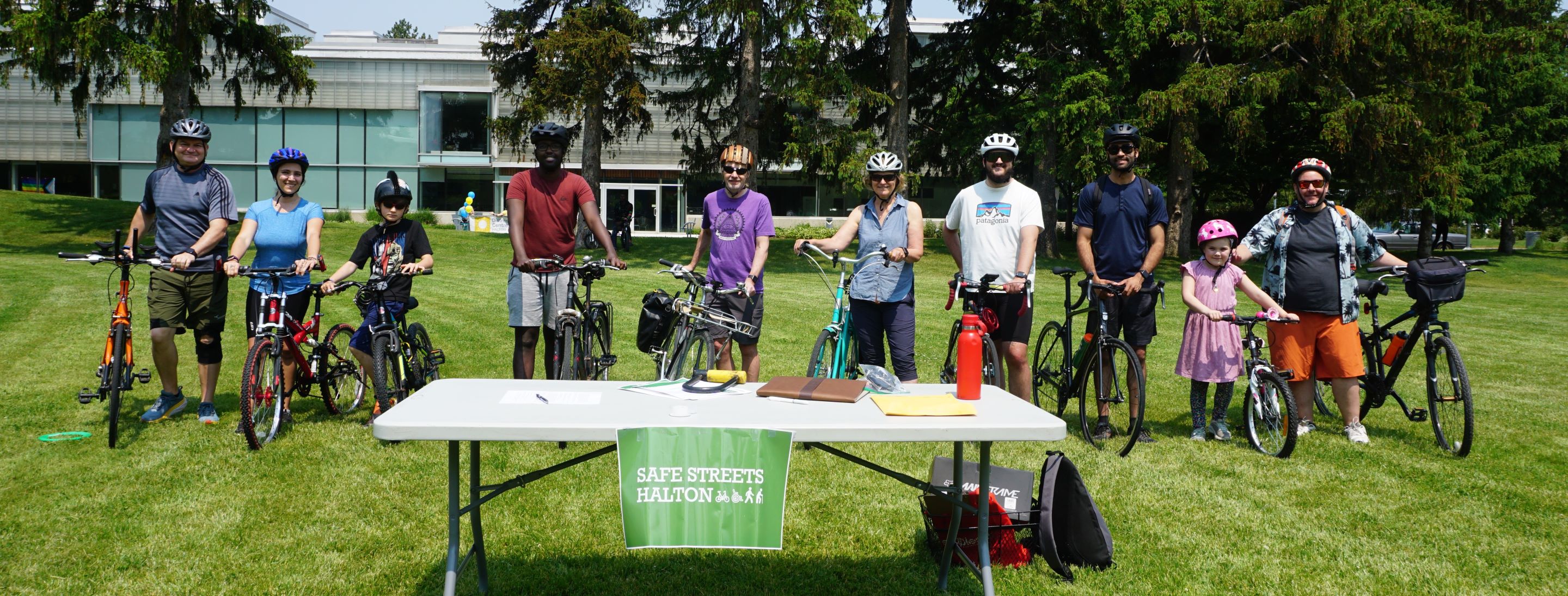 people with bicycles smiling, getting ready for a group ride